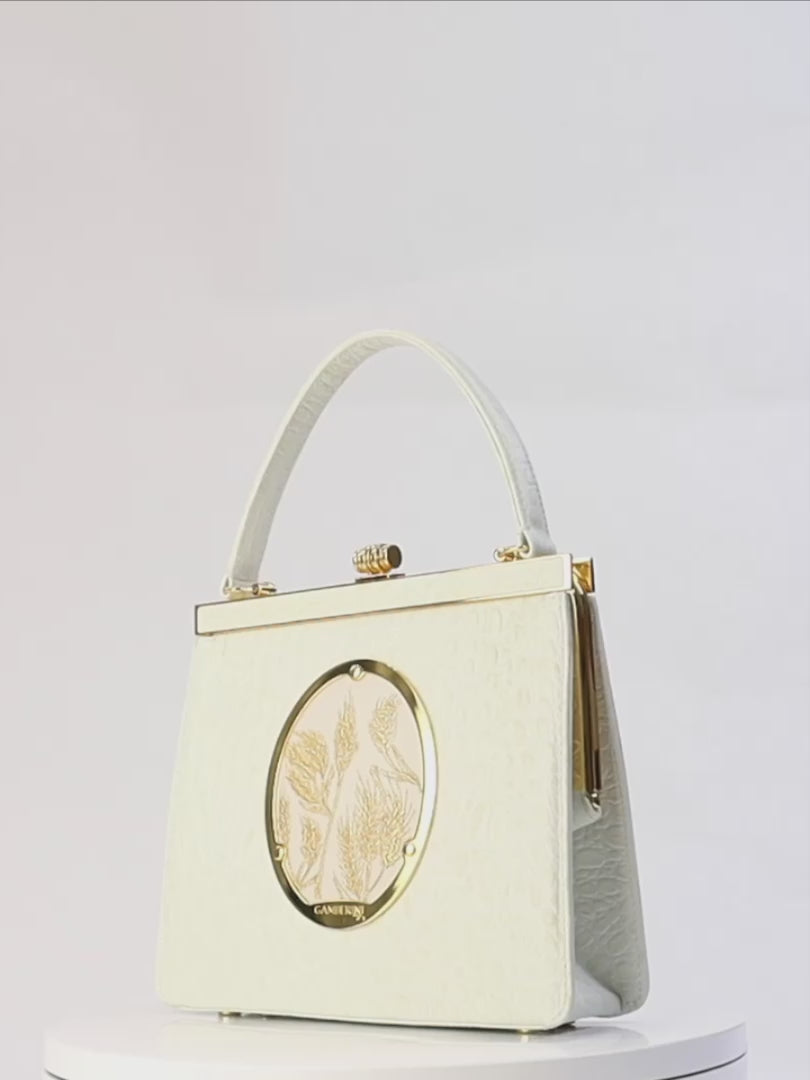 Maria Bag – Luxury Italian Handbag with Timeless Elegance. Traditional Italian craftsmanship with modern aesthetics. 18K gold-plated oval frame, adorned with hand embroidered golden wheat.