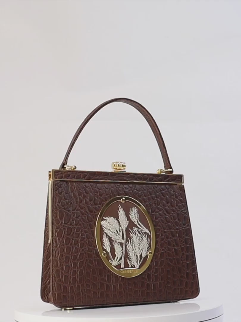 Maria Bag – Luxury Italian Handbag with Timeless Elegance. Traditional Italian craftsmanship with modern aesthetics. 18K gold-plated oval frame, adorned with hand embroidered golden wheat.