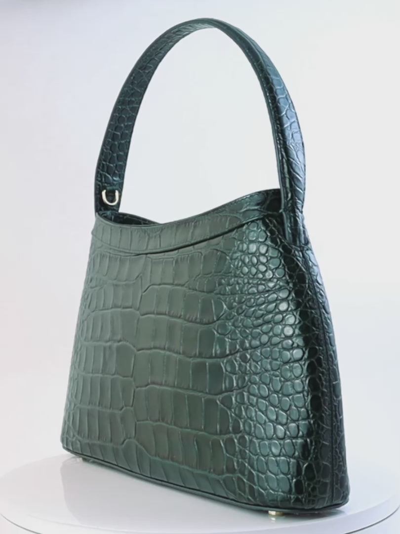 Gamberini Bag. Premium Italian calfskin leather. 18K gold-plated oval accessory. Hand-sewn embroidery.