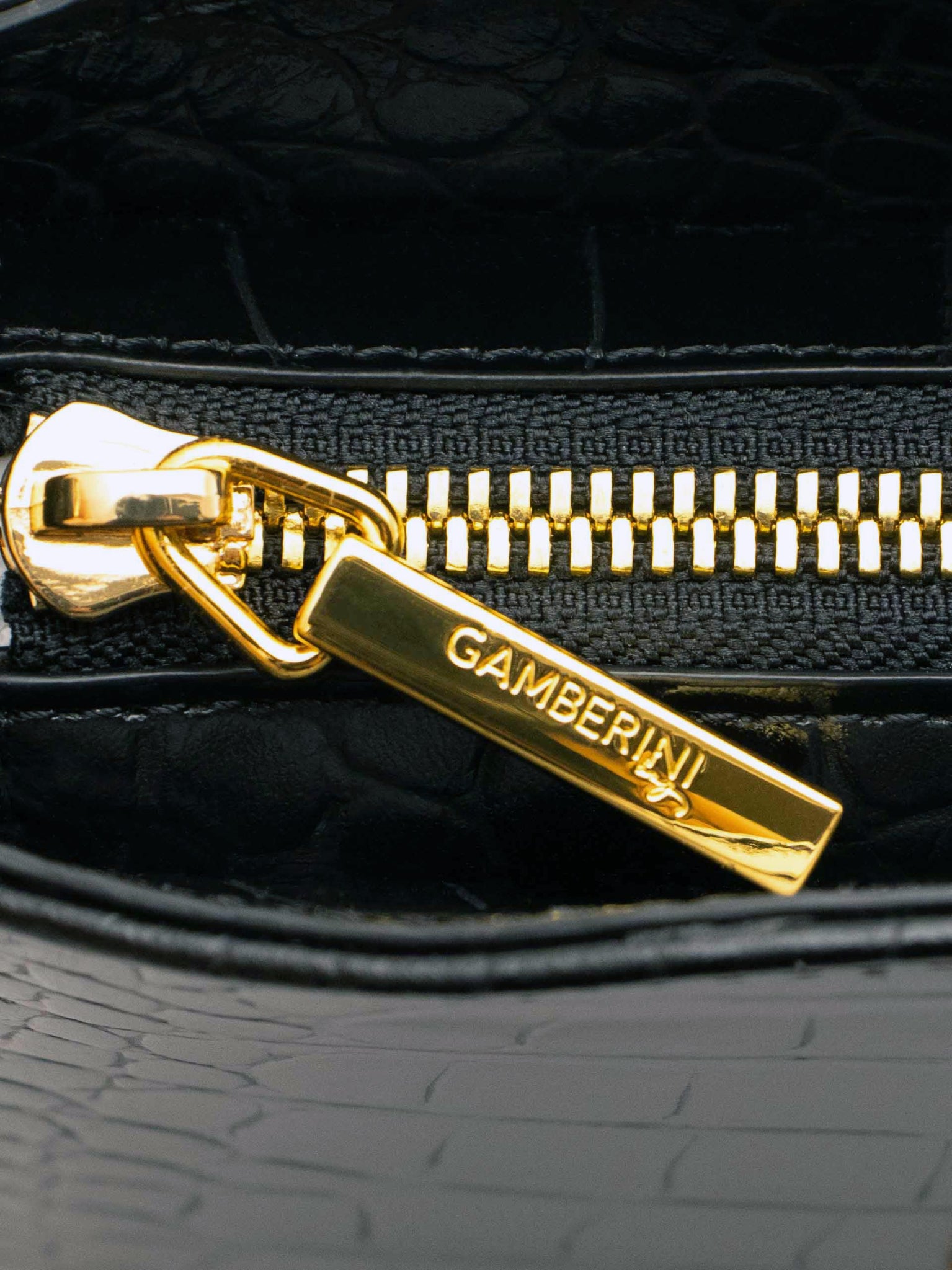 Gamberini Bag. Premium Italian calfskin leather. 18K gold-plated oval accessory.   Timeless Italian elegance.