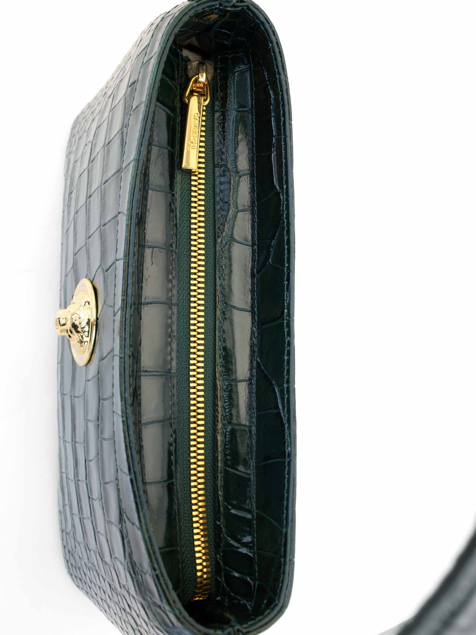 Gamberini Bag. Premium Italian calfskin leather. 18K gold-plated oval accessory. Hand-sewn embroidery. 