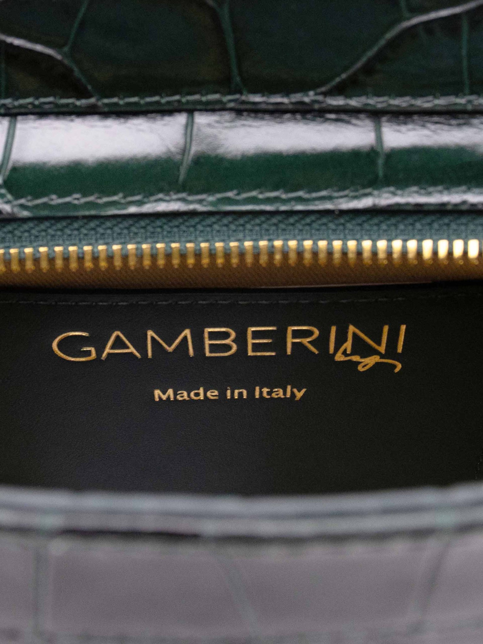 Gamberini Bag. Premium Italian calfskin leather. 18K gold-plated oval accessory. Hand-sewn embroidery. 