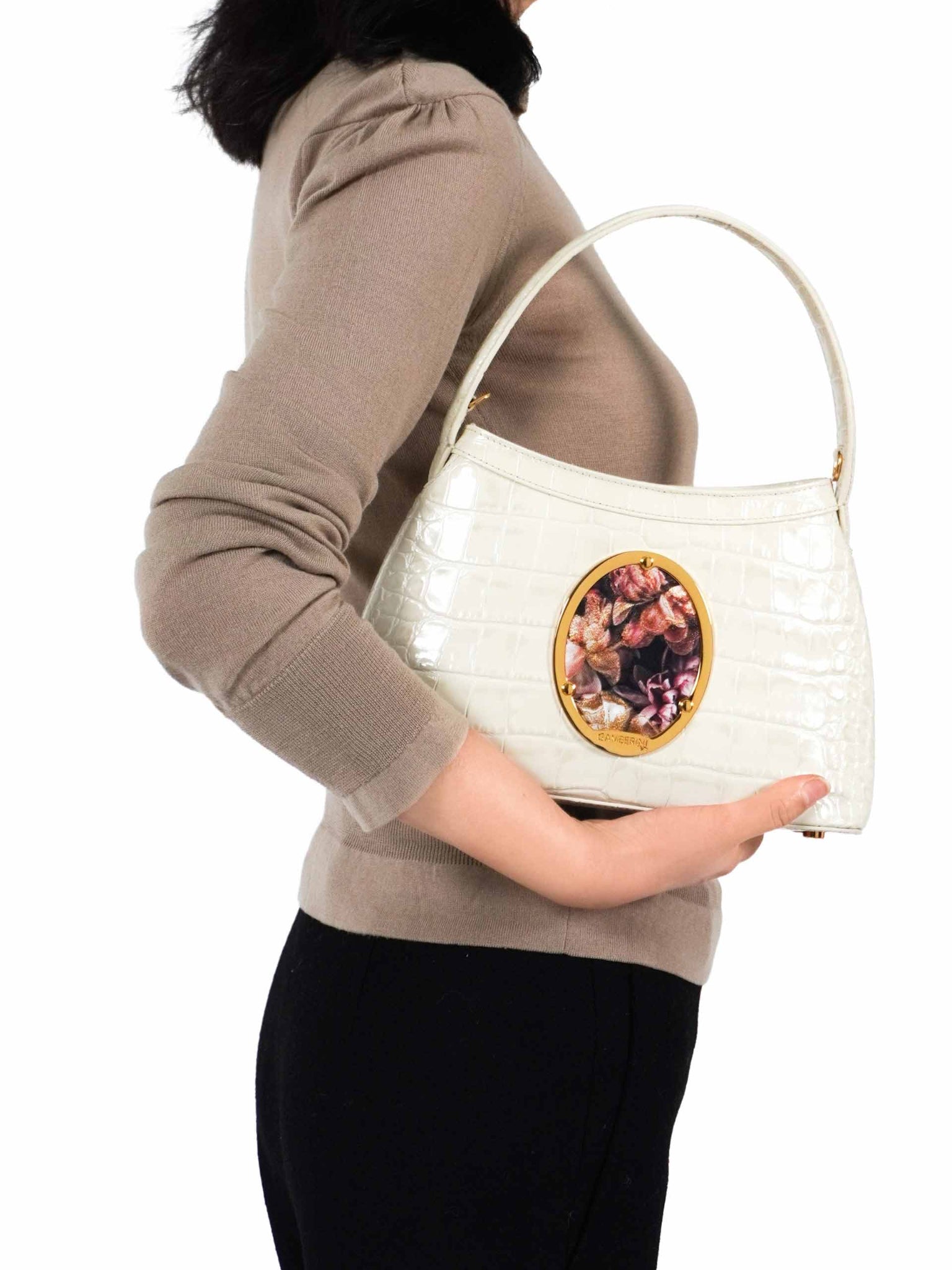 Gamberini Bag. Premium Italian calfskin leather. 18K gold-plated oval accessory. Hand-sewn embroidery. 