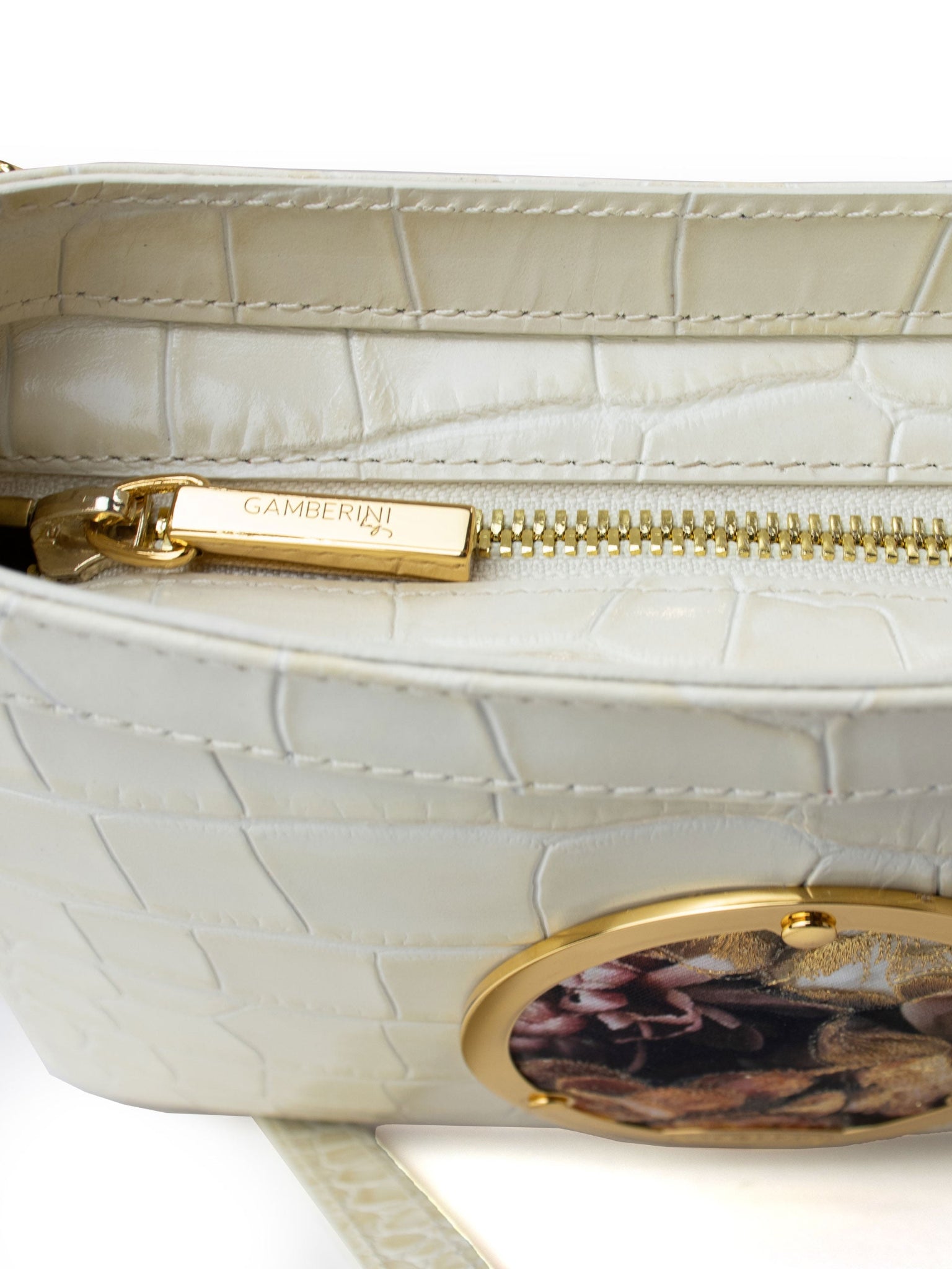 Gamberini Bag. Premium Italian calfskin leather. 18K gold-plated oval accessory. Hand-sewn embroidery. 