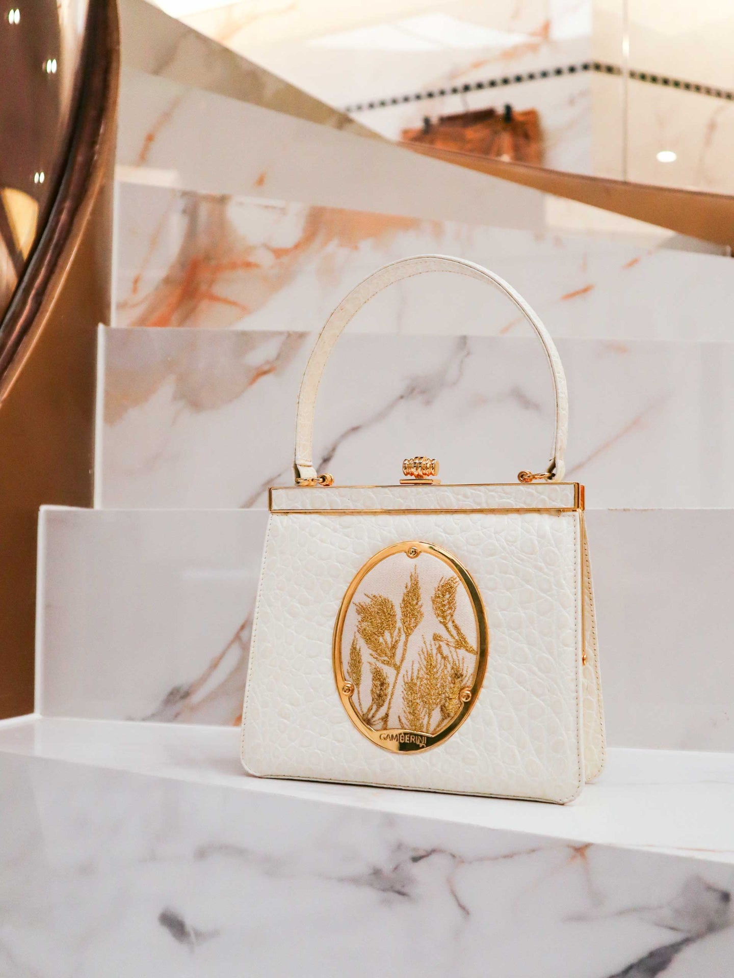 Maria Bag – Luxury Italian Handbag with Timeless Elegance. Traditional Italian craftsmanship with modern aesthetics.  18K gold-plated oval frame, adorned with hand embroidered golden wheat.