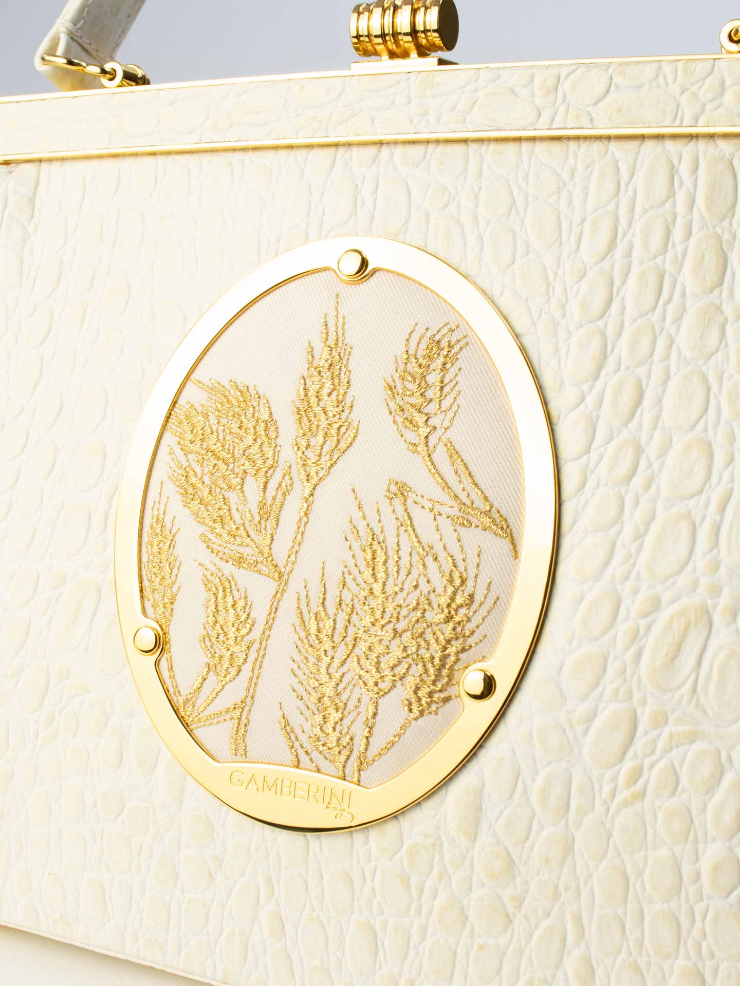 Maria Bag – Luxury Italian Handbag with Timeless Elegance. Traditional Italian craftsmanship with modern aesthetics.  18K gold-plated oval frame, adorned with hand embroidered golden wheat.